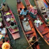 Farmers buying and selling produce at Tha Kha floating market. Visit this authentic market on our private floating market tour from Bangkok.