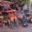 A holy tree wrapped in clothes of seven colours on a street in Chinatown