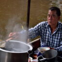 Vendor cooking delicious Boat Noodles at Damnoen Saduak floating market. Enjoy the delicious noodles on our floating market tour from Bangkok.