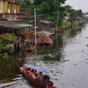 A boat giving tourist a tour of Damnoen Saduak floating market