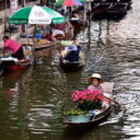 Vendors selling flowers and fruits at Damnoen Saduak floating market