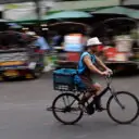 Vendor using a bicycle to get around Bangkok's biggest flower market