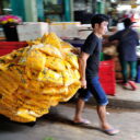 Marigolds being transported to vendors at the flower market who will turn them into garlands  