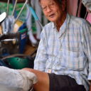 A tricycle rider taking a break at the Railway market in Samut Songkram. See it on our railway market tour from Bangkok.