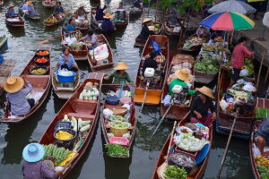 Visit Tha Kha floating market on a tour from Bangkok ✅. One of the last traditional floating markets in Thailand, it opens in the weekend.