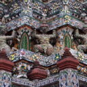Demons supporting the stupa decorated with pieces of Chinese porcelain at Wat Arun, the Temple of Dawn