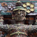 A demon supporting the stupa decorated with pieces of Chinese porcelain at Wat Arun, the Temple of Dawn