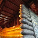 Mother of pearl inlay depicting auspicious signs on the feet of the Reclining Buddha at Wat Pho. Visit the reclining Buddha temple with our tour guide on our private tours in Bangkok.