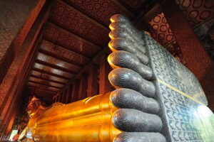 Visit Wat Pho on a Bangkok tour. Highlight of the temple is the impressive Reclining Buddha with intricate mother of pearl decorations.