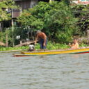 Family on long tailed boat on Chao Phraya river to Ayutthaya
