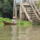 Lady fishing from a small boat on Chao Phraya river to Ayutthaya